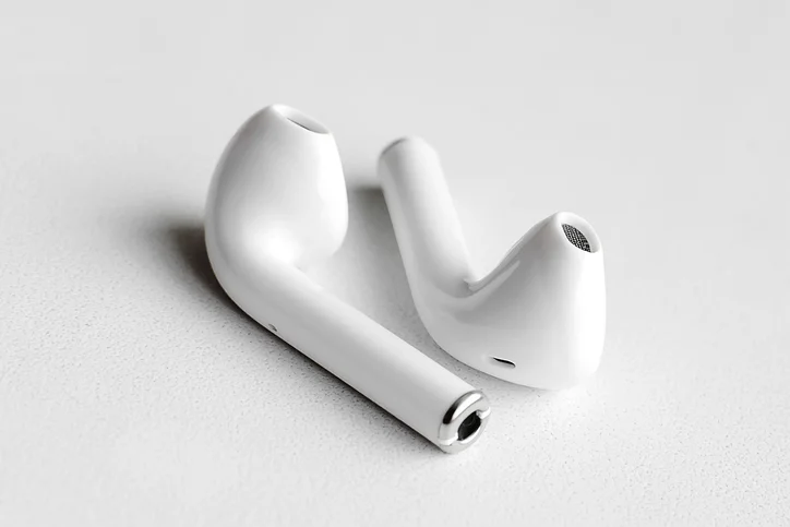 A pair of plastic, wireless headphones on a white background.