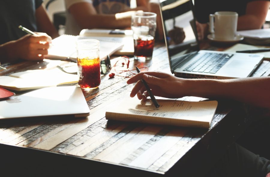 Members of a startup company discuss details over coffee.