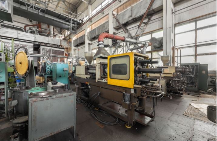 Plastic molding machinery in a factory.
