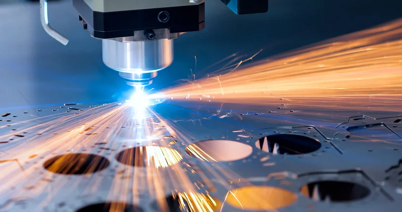 A CNC machine is milling away at a piece of metal, sending sparks flying in all directions. This machining process is more precise than others, such as 3D printing.