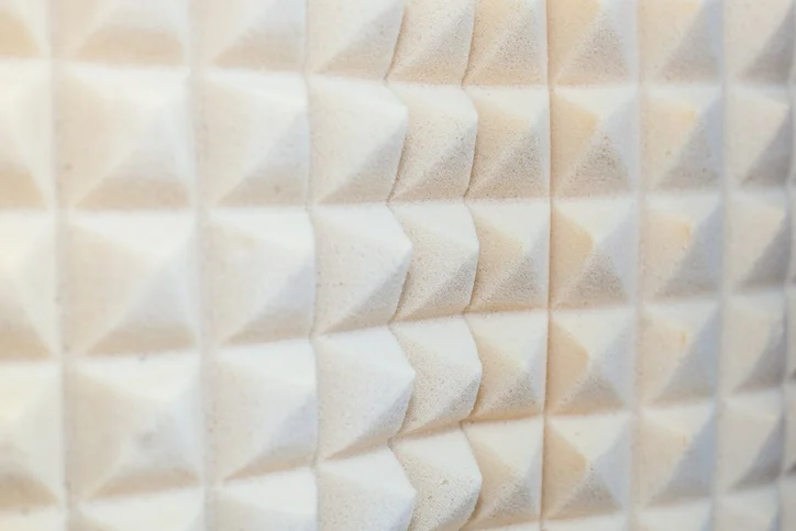 A closeup of white, plastic foam soundproofing material.